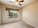 Bedroom featuring carpet, a ceiling fan, neutral walls and a large window at 16800 E El Lago Blvd # 2062, Fountain Hills, AZ 85268