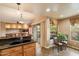 Bright kitchen showcasing a breakfast nook with table and chairs, granite countertops and backyard views at 16800 E El Lago Blvd # 2062, Fountain Hills, AZ 85268