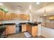 Well-lit kitchen featuring wood cabinets, dark countertops, stainless steel dishwasher and tile flooring at 16800 E El Lago Blvd # 2062, Fountain Hills, AZ 85268