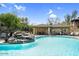 Relaxing community pool area with a cascading rock feature and covered seating offering a resort-like experience at 16800 E El Lago Blvd # 2062, Fountain Hills, AZ 85268