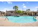 Community pool showcasing a waterfall feature, covered seating, and ample lounge chairs for relaxing poolside at 16800 E El Lago Blvd # 2062, Fountain Hills, AZ 85268