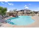 Community pool featuring a waterfall feature, covered seating, and lounge chairs, creating a comfortable atmosphere at 16800 E El Lago Blvd # 2062, Fountain Hills, AZ 85268