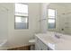 Bright bathroom featuring a single sink vanity, tile floor, and shower/bath at 17165 W Corrine Dr, Surprise, AZ 85388