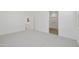 Empty bedroom with neutral walls and carpet, and a doorway to a closet at 17165 W Corrine Dr, Surprise, AZ 85388