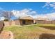 Wide shot of a backyard featuring lush grass, a covered patio, and privacy fencing at 1753 E Pinto Dr, Gilbert, AZ 85296