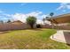 View of a spacious green backyard with a block fence and covered patio at 1753 E Pinto Dr, Gilbert, AZ 85296