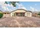 The backyard is low maintenance with a rock covering and covered patio at 18033 W Carmen Dr, Surprise, AZ 85388