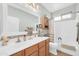 Well-lit bathroom featuring a single sink vanity and a shower-tub combination at 18033 W Carmen Dr, Surprise, AZ 85388