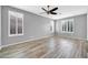 Well-lit bedroom with plantation shutters and modern ceiling fan at 18033 W Carmen Dr, Surprise, AZ 85388
