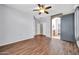 Spacious bedroom boasts wood floors, a sliding barn door, and an arched doorway at 18033 W Carmen Dr, Surprise, AZ 85388