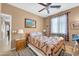 Cozy bedroom with carpet floors and a window providing ample natural light and a ceiling fan at 18033 W Carmen Dr, Surprise, AZ 85388