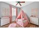 Stylized bedroom features a cozy teepee, a ceiling fan, and matching pink decor at 18033 W Carmen Dr, Surprise, AZ 85388
