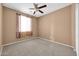 Neutral bedroom with a ceiling fan and carpet, ready for personalization at 18033 W Carmen Dr, Surprise, AZ 85388
