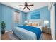 The updated bedroom features a neutral color palette, with matching decor, a bed, and a ceiling fan at 18033 W Carmen Dr, Surprise, AZ 85388