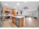 Open-concept kitchen featuring modern stainless steel appliances and a large island at 18033 W Carmen Dr, Surprise, AZ 85388