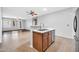 Open kitchen with stainless steel dishwasher, white countertops, and natural wood cabinetry at 18033 W Carmen Dr, Surprise, AZ 85388