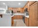 Kitchen with stainless steel appliances, wooden cabinets, and modern countertops at 18033 W Carmen Dr, Surprise, AZ 85388