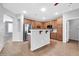 Open kitchen with an island, stainless appliances, and wooden cabinets with white countertops at 18033 W Carmen Dr, Surprise, AZ 85388