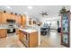 Charming kitchen featuring tile floors, breakfast bar, stainless steel appliances, and eat-in dining space at 18033 W Carmen Dr, Surprise, AZ 85388