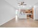 Neutral-colored living room featuring a kitchen counter and stainless steel appliances at 18033 W Carmen Dr, Surprise, AZ 85388
