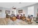 Comfortable living room showcasing wood-look floors, ceiling fans, and neutral paint colors at 18033 W Carmen Dr, Surprise, AZ 85388