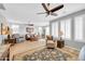 Bright and airy living room with a ceiling fan and multiple seating options for relaxing or entertaining guests at 18033 W Carmen Dr, Surprise, AZ 85388