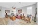 Comfortable living room featuring hard wood floors, ceiling fan, and multiple seating arrangements at 18033 W Carmen Dr, Surprise, AZ 85388