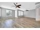 Bright living room with plantation shutters and modern ceiling fan at 18033 W Carmen Dr, Surprise, AZ 85388