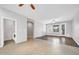 Bright living room featuring two-toned flooring, neutral paint, and a sliding door at 18033 W Carmen Dr, Surprise, AZ 85388