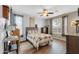 Inviting main bedroom with wood floors, a ceiling fan, and natural light from the window at 18033 W Carmen Dr, Surprise, AZ 85388