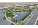 Aerial view of community featuring pickleball courts, lush lawns, mature landscaping, and community gathering place at 1804 E Amaranth Trl, Queen Creek, AZ 85140