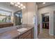 Bathroom with double vanity, walk-in closet, and view of the tiled glass walk-in shower at 1804 E Amaranth Trl, Queen Creek, AZ 85140