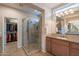 Bathroom with tiled glass walk-in shower and large mirror with dual vanity at 1804 E Amaranth Trl, Queen Creek, AZ 85140