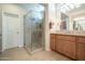 Bathroom featuring a glass enclosed shower and wooden cabinets at 1804 E Amaranth Trl, Queen Creek, AZ 85140