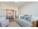 Bright bedroom featuring a daybed, chair, and entry to another room at 1804 E Amaranth Trl, Queen Creek, AZ 85140