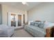 Bright bedroom featuring a daybed, chair, and entry to another room at 1804 E Amaranth Trl, Queen Creek, AZ 85140