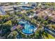 Aerial shot showcases the community pool area, complete with palm trees and ample lounge chairs at 1804 E Amaranth Trl, Queen Creek, AZ 85140