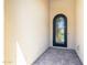 Entrance to the property showcasing an arched front door with wrought iron accents and stone pavers at 1804 E Amaranth Trl, Queen Creek, AZ 85140