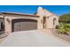 A charming exterior with a garage and decorative stone accents offering curb appeal to this beautiful home at 1804 E Amaranth Trl, Queen Creek, AZ 85140