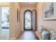 Foyer featuring an ornate front door open to outside, bench with decorative pillows, and neutral wall color at 1804 E Amaranth Trl, Queen Creek, AZ 85140