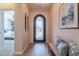 Bright foyer with decorative front door, tile flooring, bench with decorative pillows, and tasteful wall decor at 1804 E Amaranth Trl, Queen Creek, AZ 85140