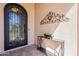 An inviting entryway with ornate front door, decorative console table, and elegant design enhancing curb appeal at 1804 E Amaranth Trl, Queen Creek, AZ 85140