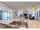 Gourmet kitchen featuring a stainless steel sink, pendant lighting, and seamless flow to the living area at 1804 E Amaranth Trl, Queen Creek, AZ 85140