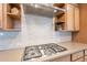 Modern kitchen featuring sleek countertops, stainless steel range hood, and custom cabinetry at 1804 E Amaranth Trl, Queen Creek, AZ 85140