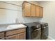 Laundry area with sink and modern washer and dryer at 1804 E Amaranth Trl, Queen Creek, AZ 85140