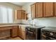 Laundry room features modern appliances, counter space, sink, and storage for convenience at 1804 E Amaranth Trl, Queen Creek, AZ 85140