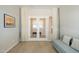 Living room view showing french doors, neutral walls, tile floors, and a cushioned sofa at 1804 E Amaranth Trl, Queen Creek, AZ 85140