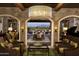 View through arched doorways of the dining and living areas, with elegant furnishings and stone walls at 1804 E Amaranth Trl, Queen Creek, AZ 85140