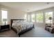 Airy main bedroom with many windows, a comfortable bed, and ample natural light at 1804 E Amaranth Trl, Queen Creek, AZ 85140