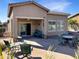 Backyard features covered patio, brick pavers, desert landscaping and outdoor seating at 19765 N Swan Ct, Maricopa, AZ 85138